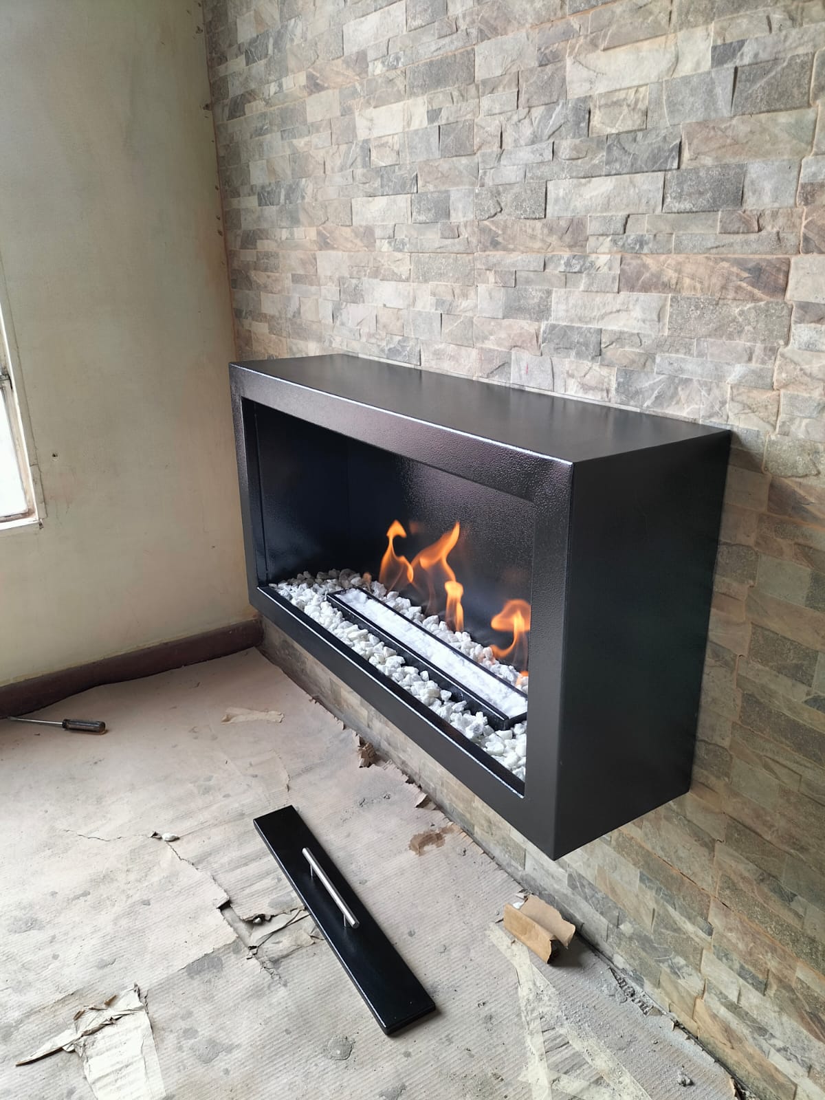 Detalle de quemador y piedras en chimenea a gas