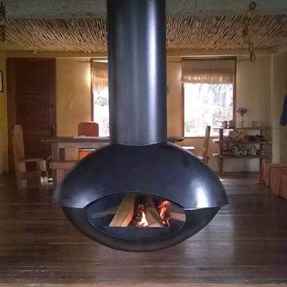 Chimenea suspendida de leña en cabaña rústica